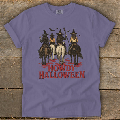 T-shirt with witches on horses, bats, and "Howdy Halloween" text.
