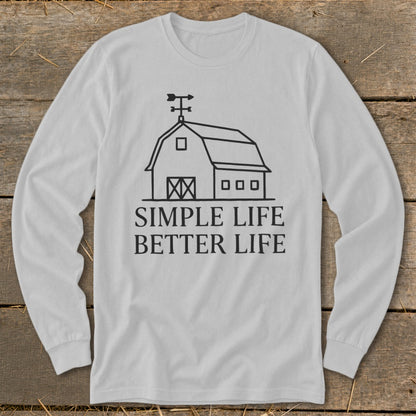 White long-sleeve shirt with a line drawing of a barn and text reading "Simple Life Better Life."