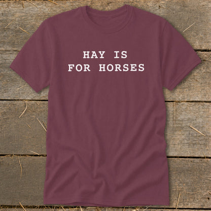 Maroon t-shirt with white text that reads "HAY IS FOR HORSES".