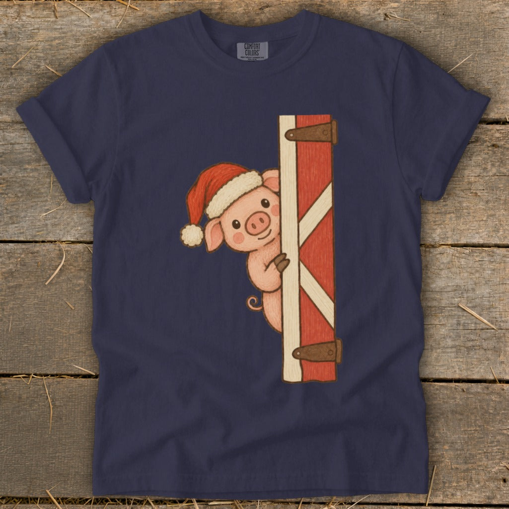 Cute pig in a Santa hat peeking around a red barn door.