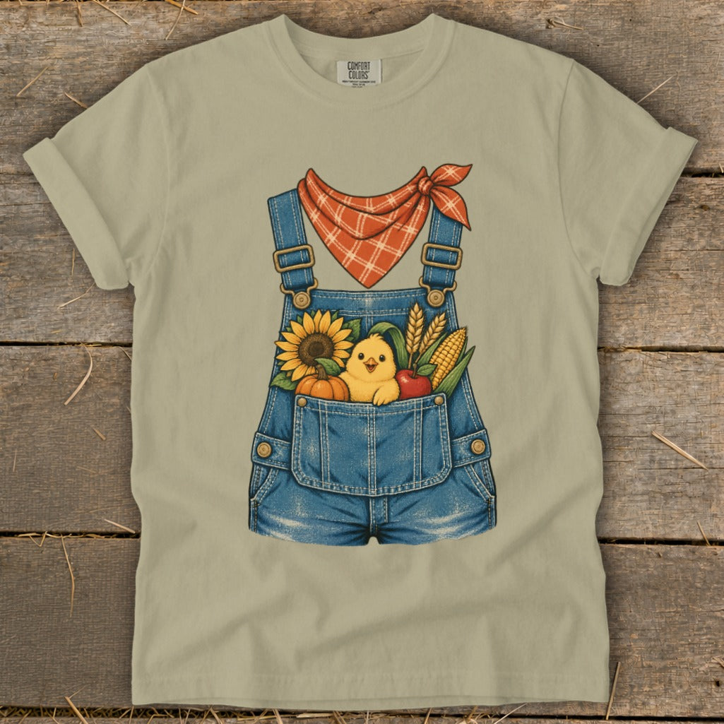 Overalls graphic with chick, sunflower, pumpkin, corn, and apple in pocket.