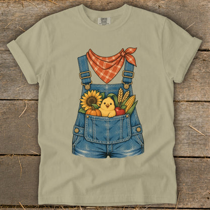 Overalls graphic with chick, sunflower, pumpkin, corn, and apple in pocket.