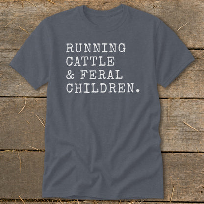 Gray t-shirt with white text reading "RUNNING CATTLE & FERAL CHILDREN."