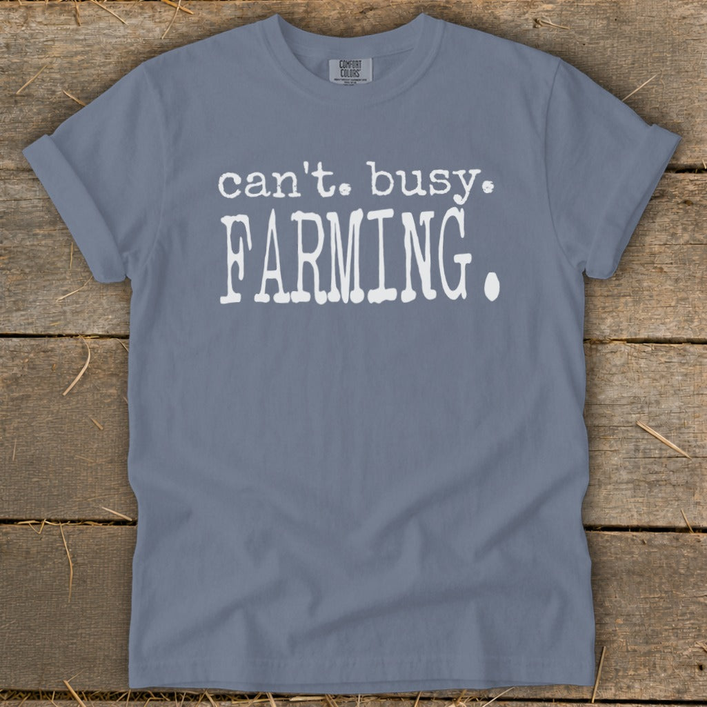 Blue t-shirt with white text: "can't. busy. FARMING."