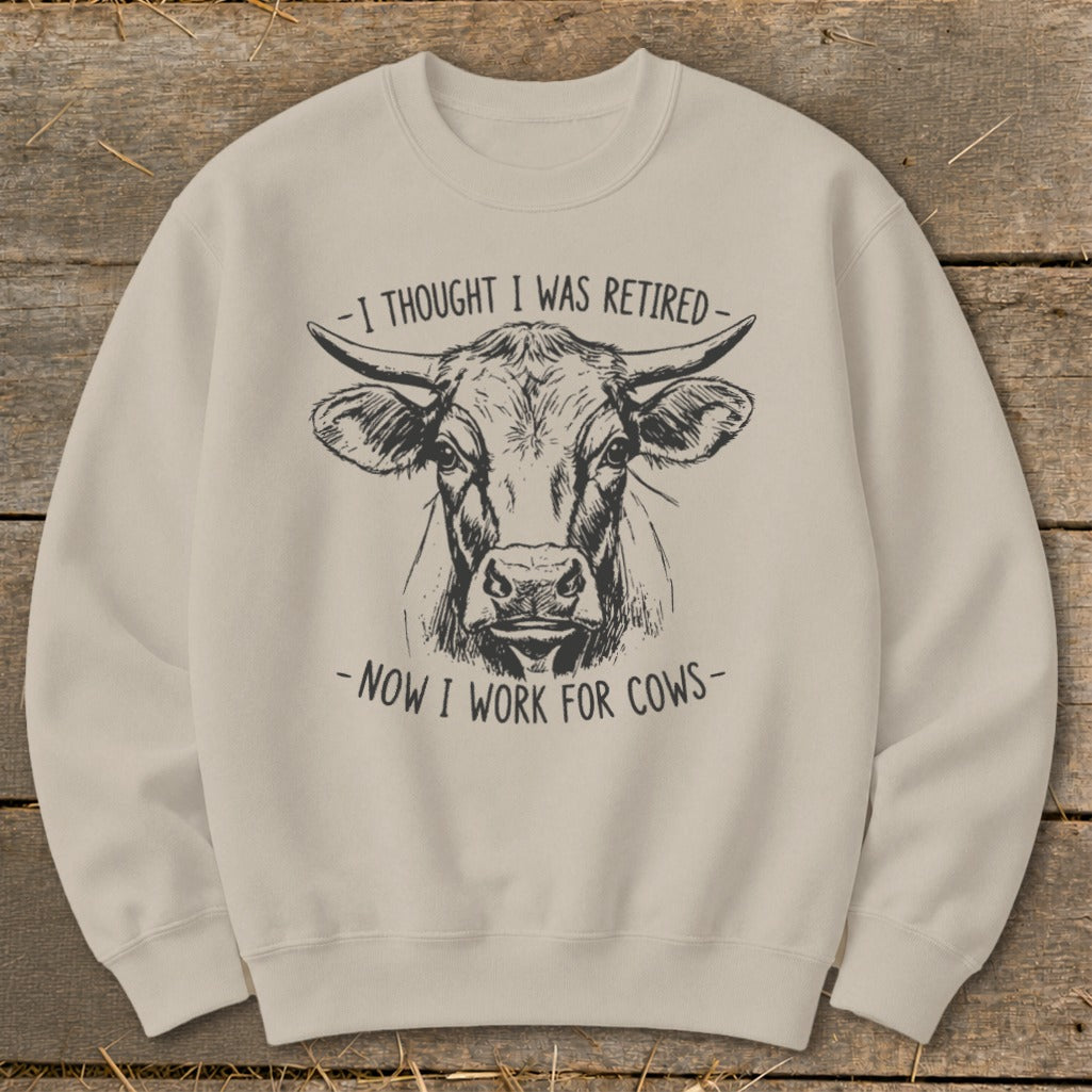 Light beige crewneck sweatshirt with a black ink sketch of a cow's head and text.