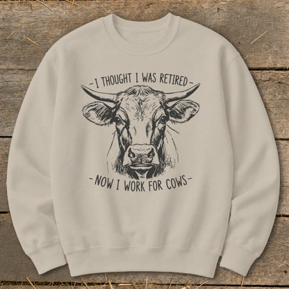 Light beige crewneck sweatshirt with a black ink sketch of a cow's head and text.