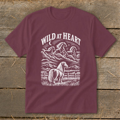 Maroon t-shirt with "Wild At Heart" text and a horse illustration with mountains and running horses.