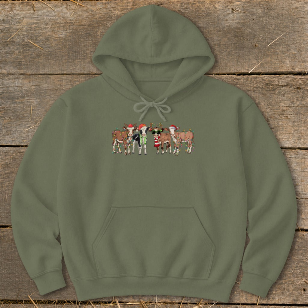 Green hoodie with a graphic of five cows wearing Santa hats and Christmas lights.