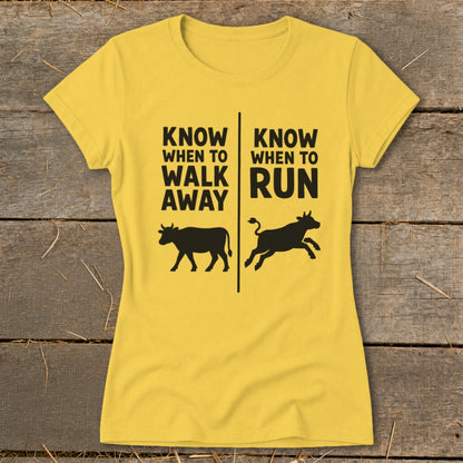 Yellow t-shirt with black text "Know When to Walk Away" and "Know When to Run" above cows.