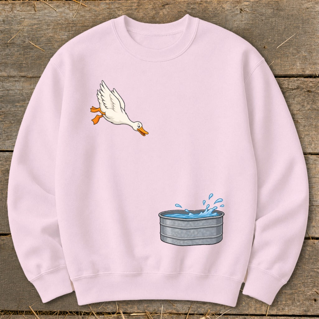 Pink sweatshirt with a cartoon duck jumping into a galvanized tub of water.