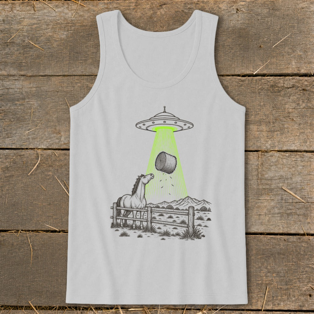 UFO abducting hay bale with horse looking up from fenced field.