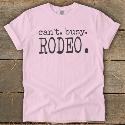 Pink t-shirt with black text "can't. busy. RODEO."