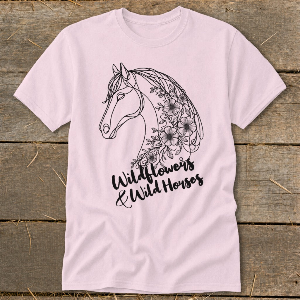 Pink t-shirt with a line drawing of a horse head adorned with wildflowers and text.