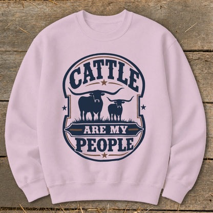 Pink sweatshirt with a circular graphic featuring two silhouetted cattle and text.