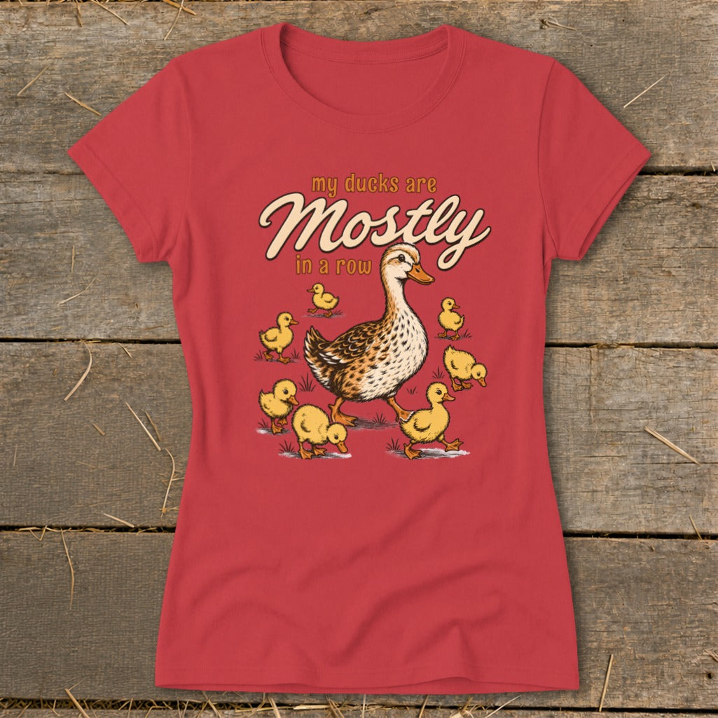 Red t-shirt with "my ducks are Mostly in a row" text and duck family illustration.