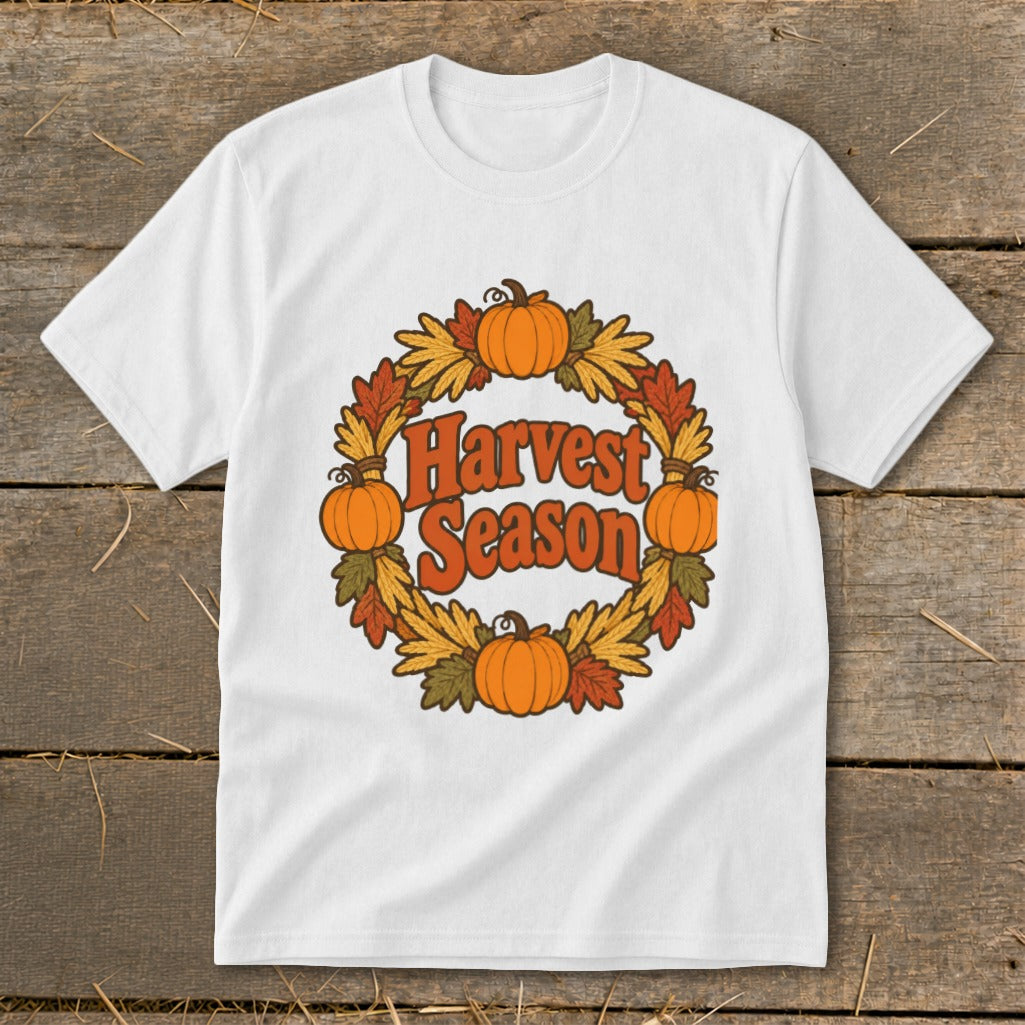 White t-shirt with "Harvest Season" text surrounded by pumpkins and autumn leaves.