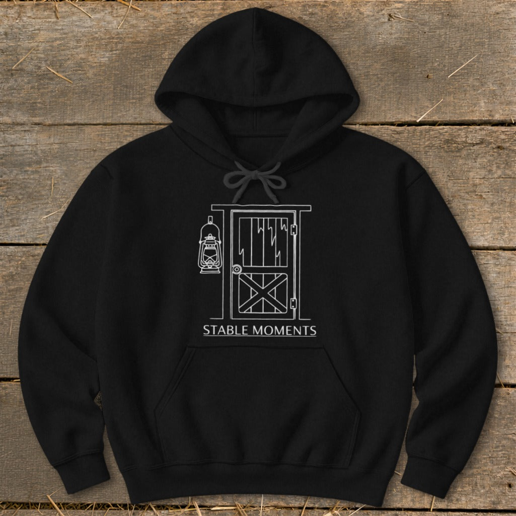 Black hoodie with white line art of a stable door, lantern, and "STABLE MOMENTS" text.