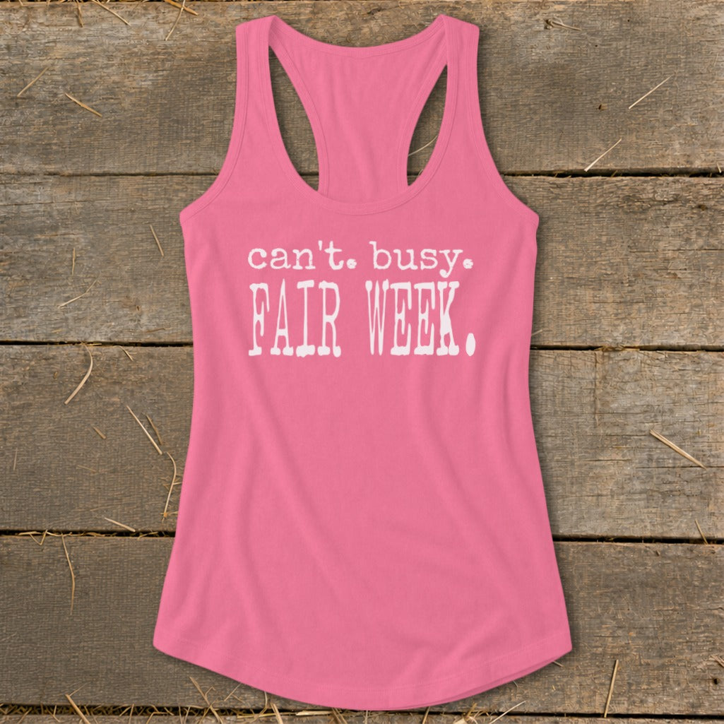 Pink racerback tank top with "can't. busy. FAIR WEEK." text.