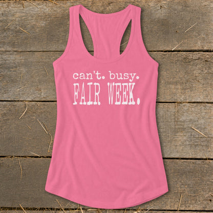 Pink racerback tank top with "can't. busy. FAIR WEEK." text.