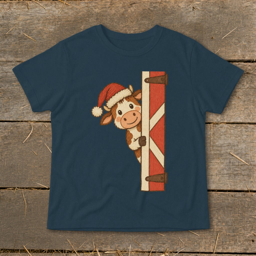 Cute cow in Santa hat peeks from behind a barn door on navy t-shirt.