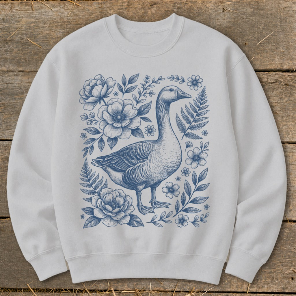 White sweatshirt with a blue goose and floral illustration on the front.