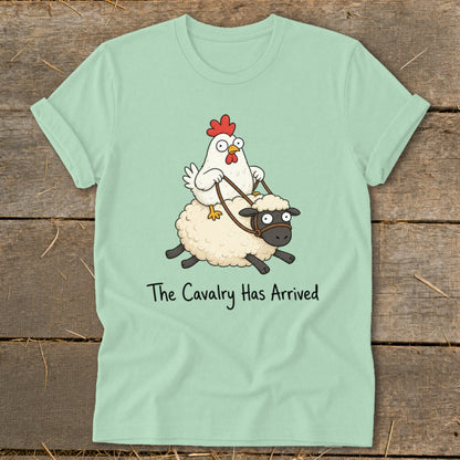 Light mint t-shirt with cartoon chicken riding a sheep, text "The Cavalry Has Arrived".