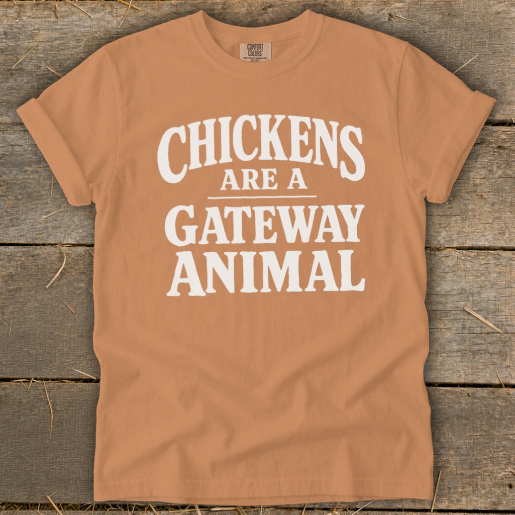 Orange t-shirt with white text that reads "Chickens Are A Gateway Animal."