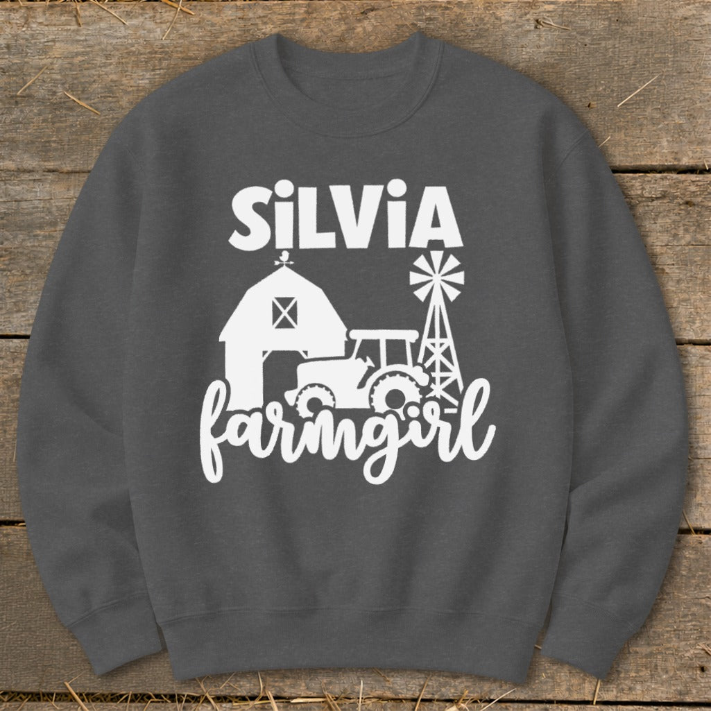 White text "SILVIA farmgirl" with farm graphic on charcoal sweatshirt.