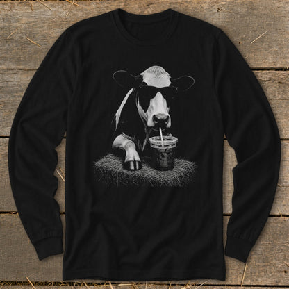 Black long-sleeve shirt featuring a cow wearing sunglasses, drinking from a cup on hay.
