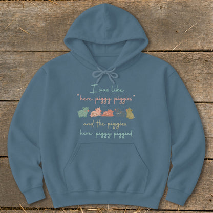 Blue hoodie with text "I was like 'here piggy piggies' and the piggies here piggy piggied" and cartoon pigs.