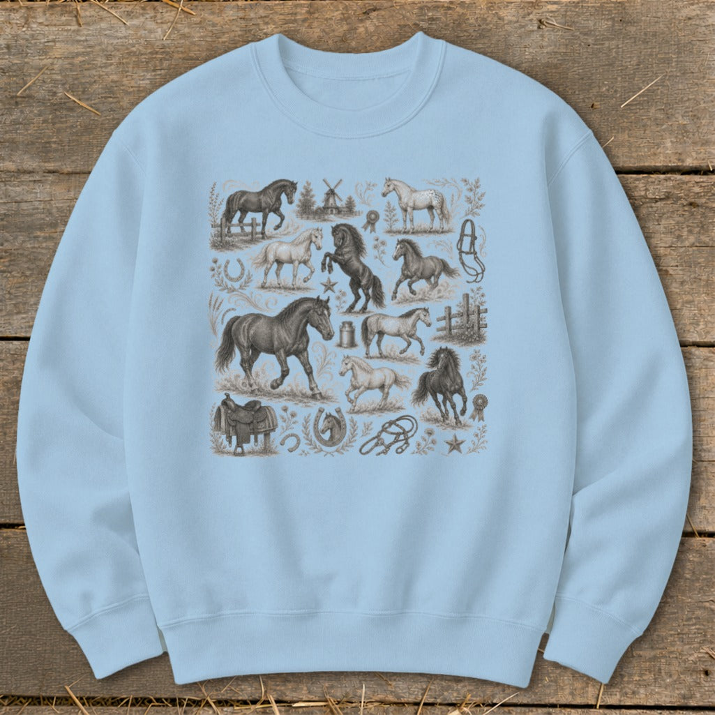 Light blue sweatshirt with vintage horse illustrations and equestrian accessories.