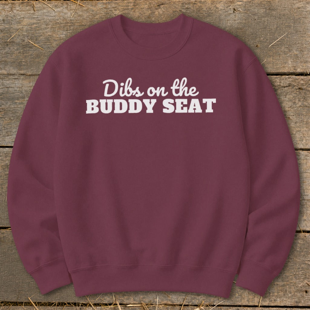 Burgundy sweatshirt with white text "Dibs on the BUDDY SEAT."