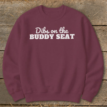 Burgundy sweatshirt with white text "Dibs on the BUDDY SEAT."