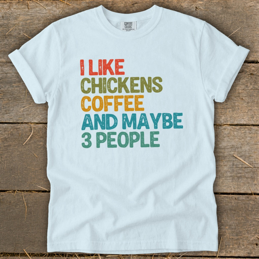 White t-shirt with text "I LIKE CHICKENS COFFEE AND MAYBE 3 PEOPLE".