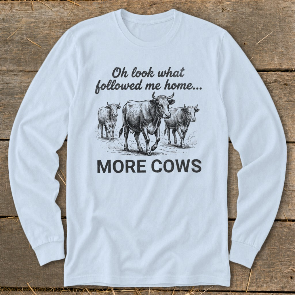 Long sleeve t-shirt with sketch of cows and text "Oh look what followed me home... MORE COWS".
