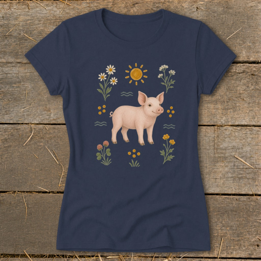 Navy t-shirt with a pink pig and floral illustration, including a sun.