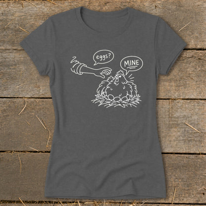 T-shirt with line drawing of hen protecting eggs, "eggs?" speech bubble and "MINE" speech bubble.