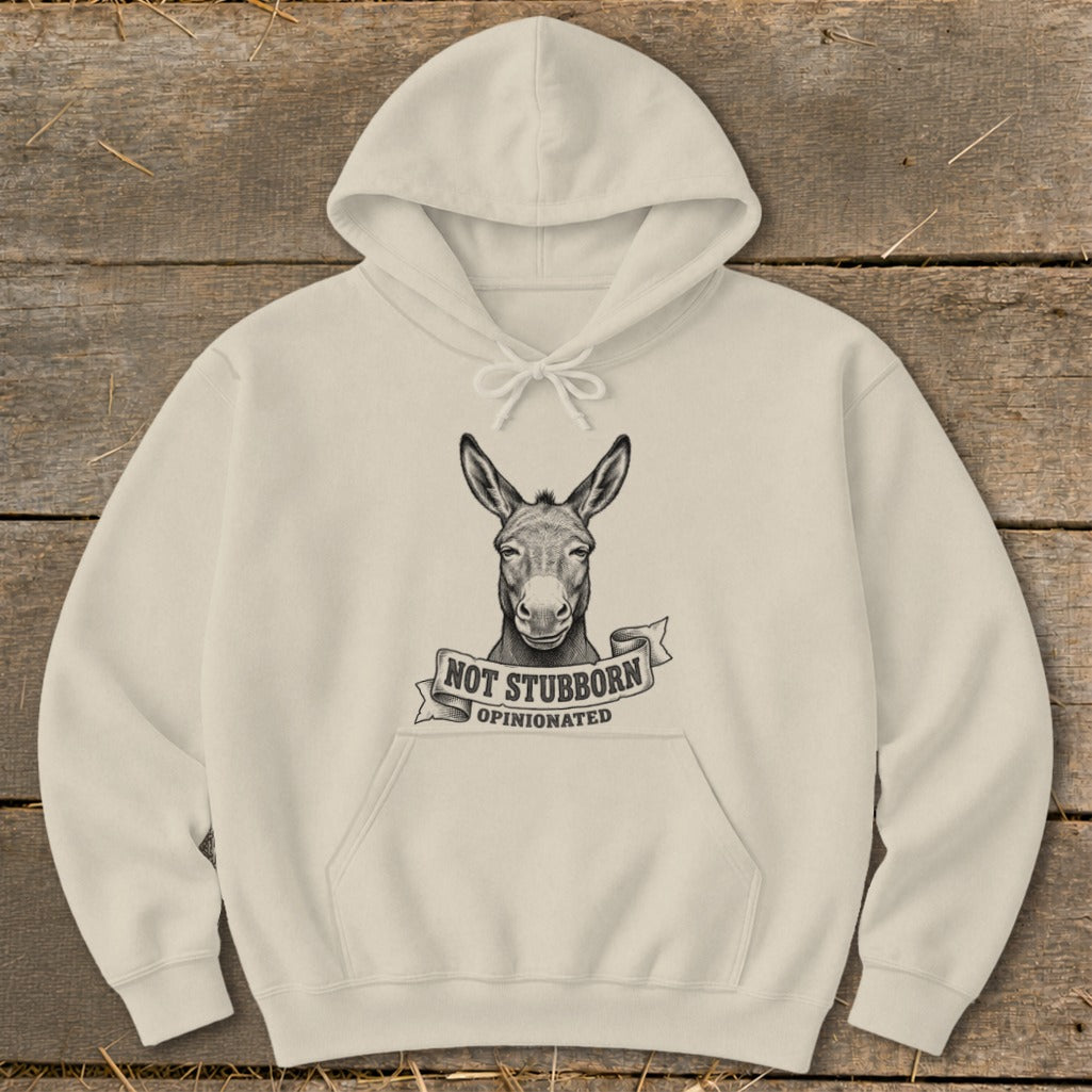 Cream hoodie with a sketch of a donkey's head and text "NOT STUBBORN OPINIONATED".