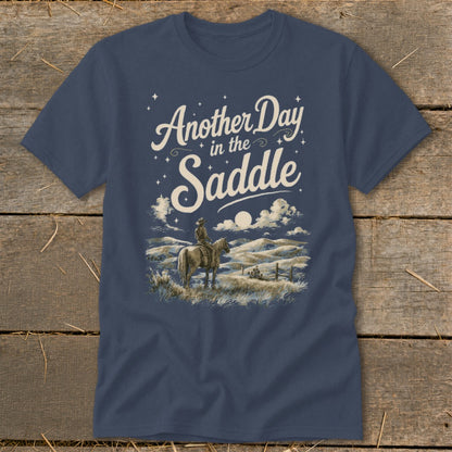 Dark blue t-shirt with "Another Day in the Saddle" text and cowboy on horseback.