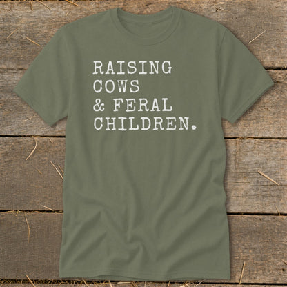 Olive green t-shirt with white text reading "RAISING COWS & FERAL CHILDREN."