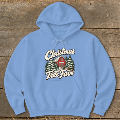 Light blue hoodie with "Christmas Tree Farm" graphic featuring a red barn and pine trees.