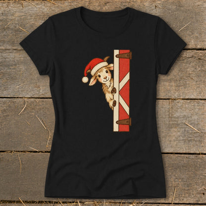 Black t-shirt with a cheerful goat wearing a Santa hat peeking around a barn door.