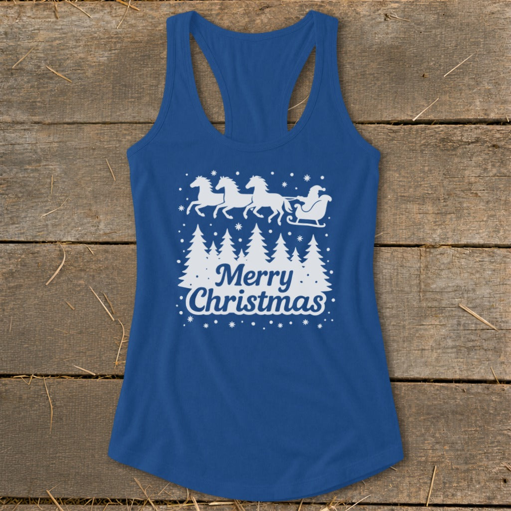 Blue tank top with white Christmas design of horses pulling sleigh and trees.