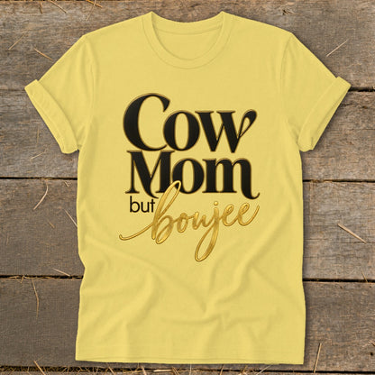 Yellow t-shirt with text "Cow Mom but boujee" in black and gold script.