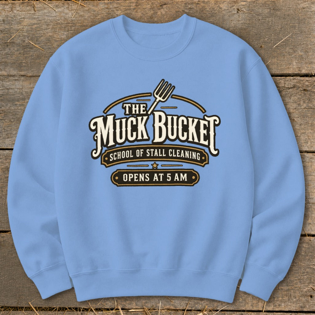 Light blue sweatshirt with "The Muck Bucket School of Stall Cleaning Opens at 5 AM" graphic.