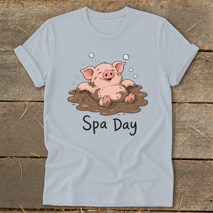 T-shirt graphic of a happy pig covered in mud, with "Spa Day" text.