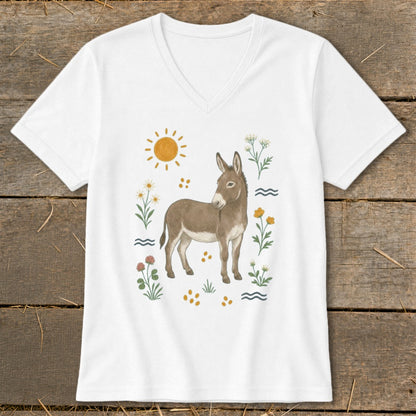 White t-shirt with a watercolor illustration of a donkey surrounded by flowers and a sun.