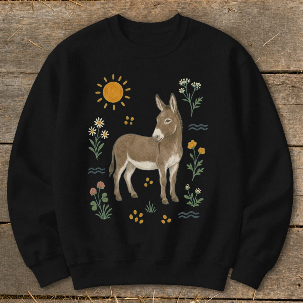 Black sweatshirt with a donkey illustration surrounded by sun, flowers, and wavy lines.
