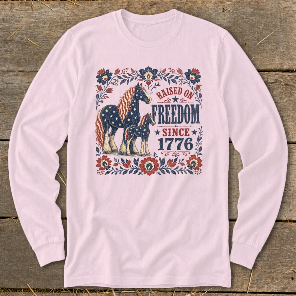 Long-sleeve shirt with American flag-themed horses and "Raised on Freedom Since 1776" text.