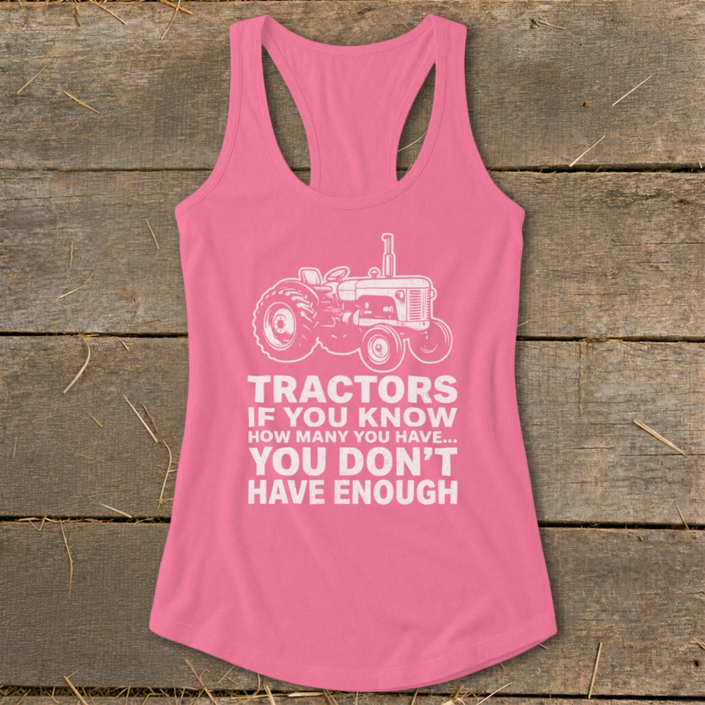 Pink tank top with a white tractor graphic and the text "Tractors if you know how many you have... you don't have enough".